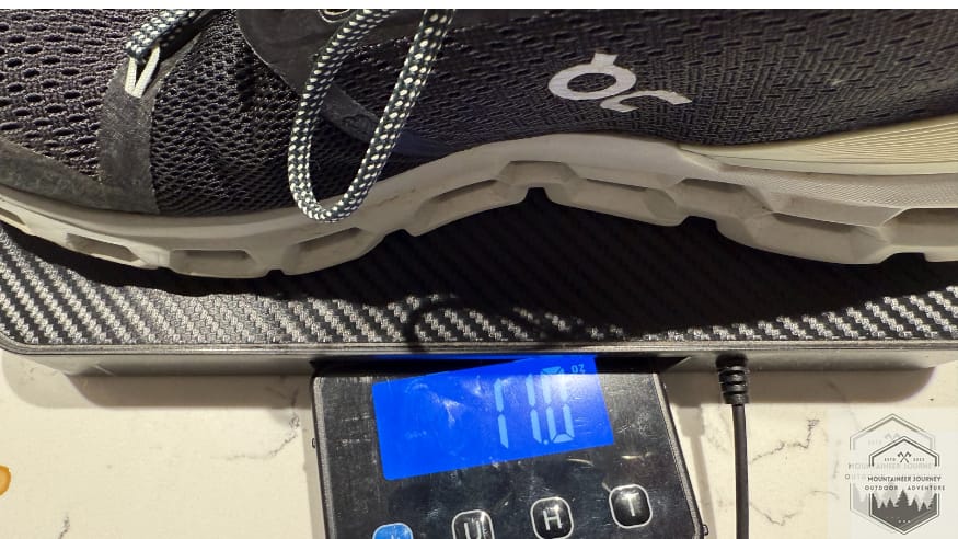 Weighing the On Cloud 6 on a digital scale at 11 oz per shoe, providing objective data on the shoe's lightweight Zero-Gravity foam construction.