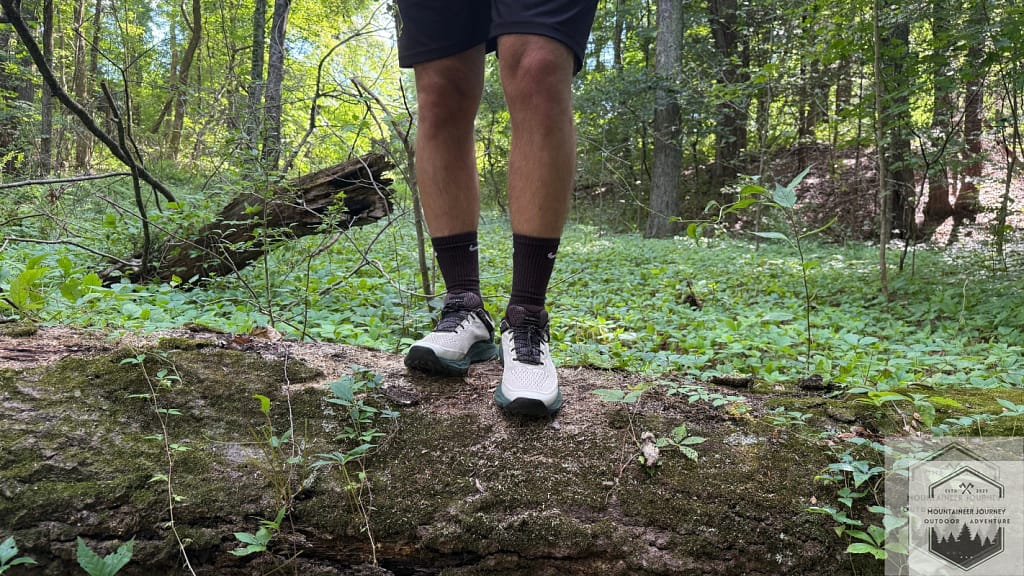 Standing on a log with the Merrell Nova 4 during testing