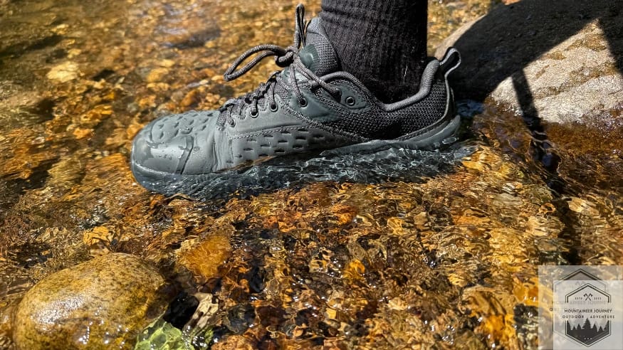 Standing in river with the Olympus X during waterproof testing