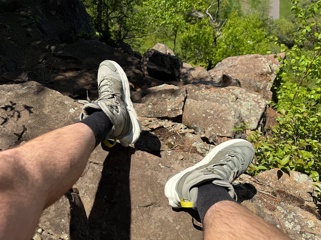 merino wool summer hiking socks while sitting on rocks