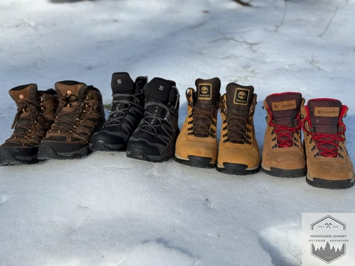 All of the best budget boots lined up next to one another in the snow highlighting the features of each