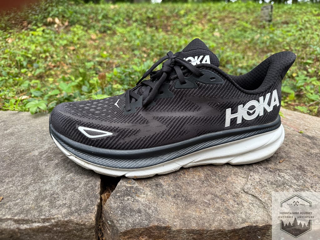 side view of the Hoka Clifton 9's on a wall, highlighting the jacquard mesh