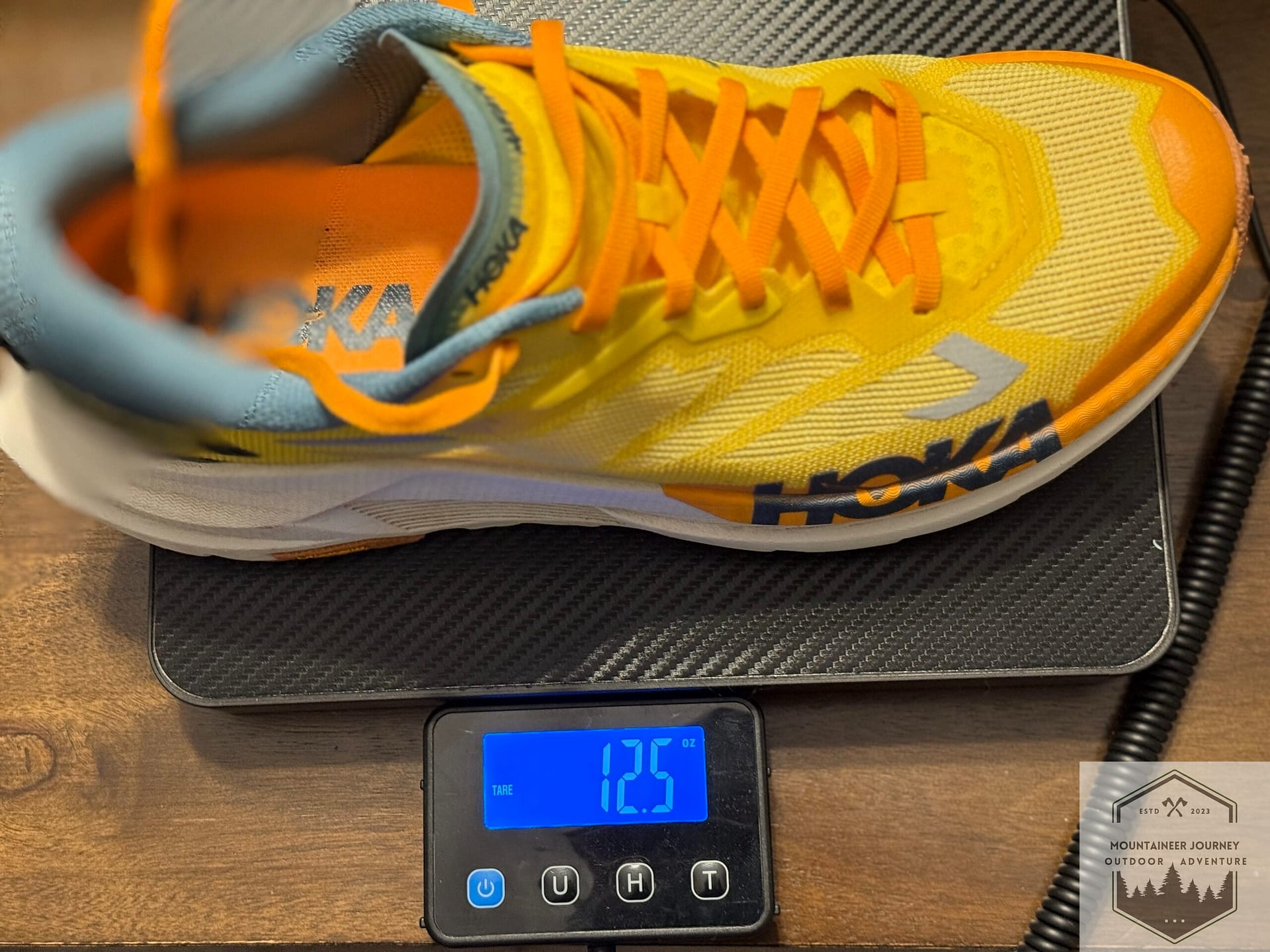 Weighing the Hoka Mafate X on a digital scale at 12.5 oz to verify the weight-to-cushion ratio for our unbiased trail review.