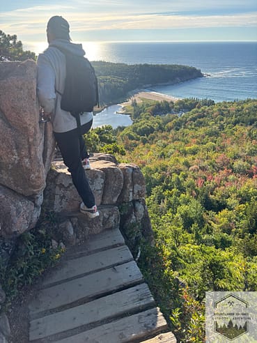 Hiking up small cliffside during Beehive Trail