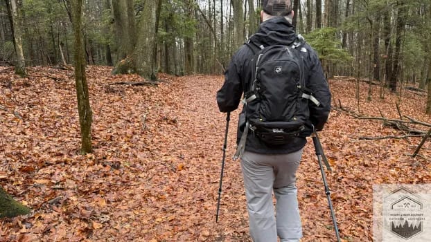 Wearing backpack with trekking poles on trail