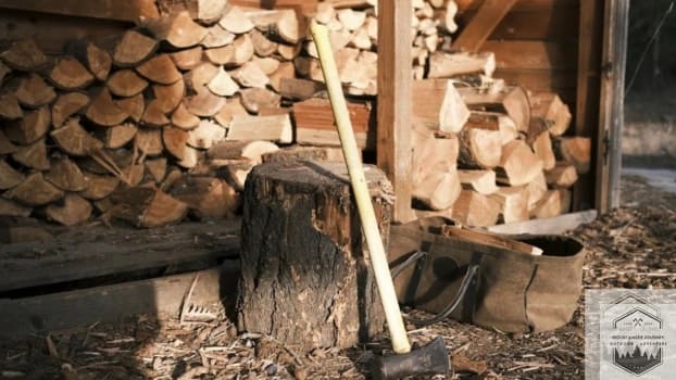 Firewood stack with axe next to it