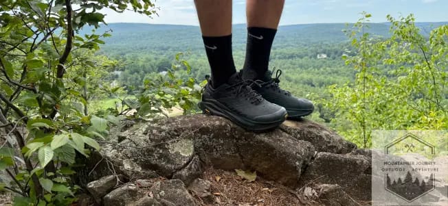 Standing at the top of a mountain summit with Altra Ultra Olympus 6