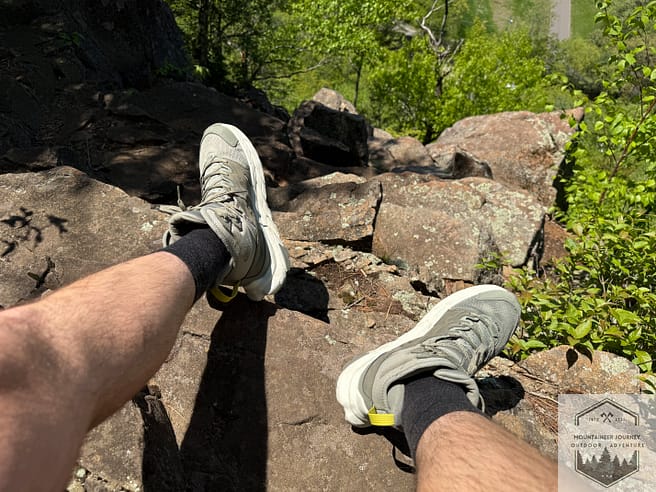 merino wool summer hiking socks while sitting on rocks