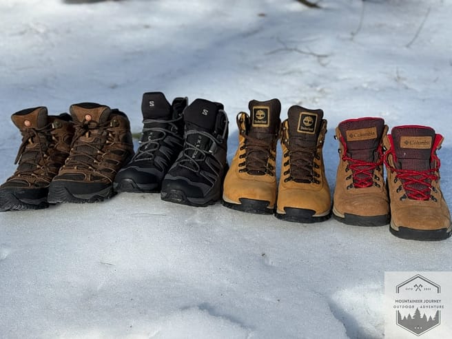 All of the best budget boots lined up next to one another in the snow highlighting the features of each