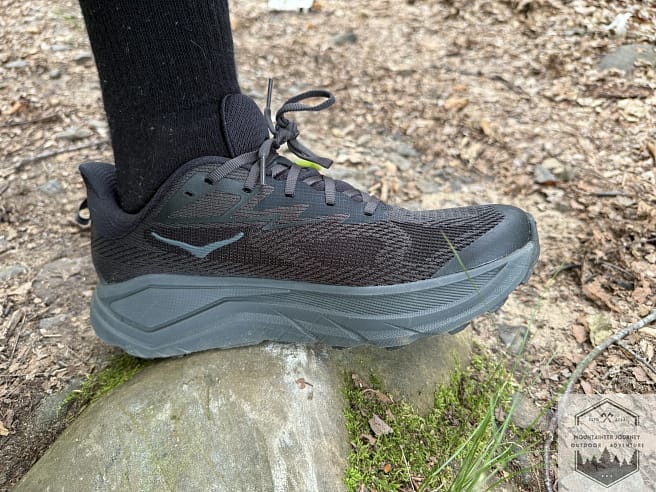 Testing the Hoka Challenger 8 protection on a sharp rock to evaluate the shock absorption of the high-stack CMEVA midsole on technical trail features.