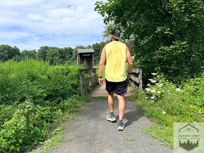 Walking on a mixed trail path during summer conditions with the Hoka Transport 2.