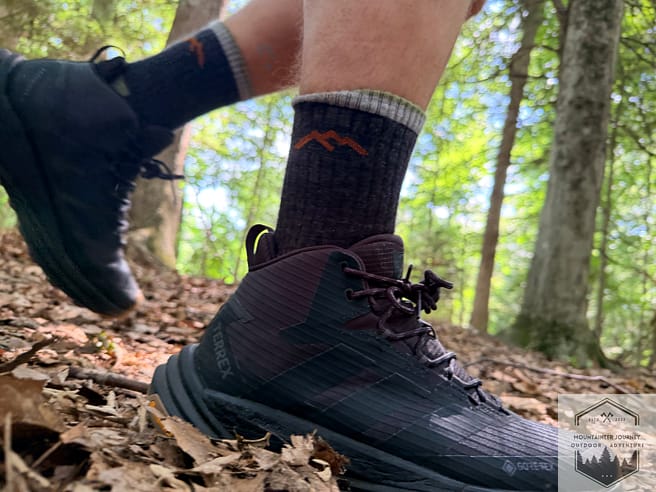 Side view of the Terrex Free Hiker 3 while on a leaf-covered trail