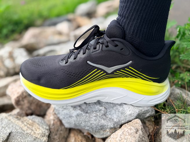 Medial side view of the Hoka Clifton 11 while standing on rocks. The outsole was nice and flexible.