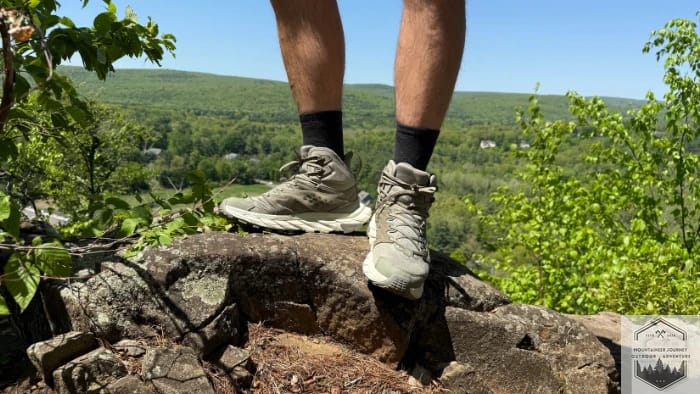 Standing a top of uneven rock wearing the