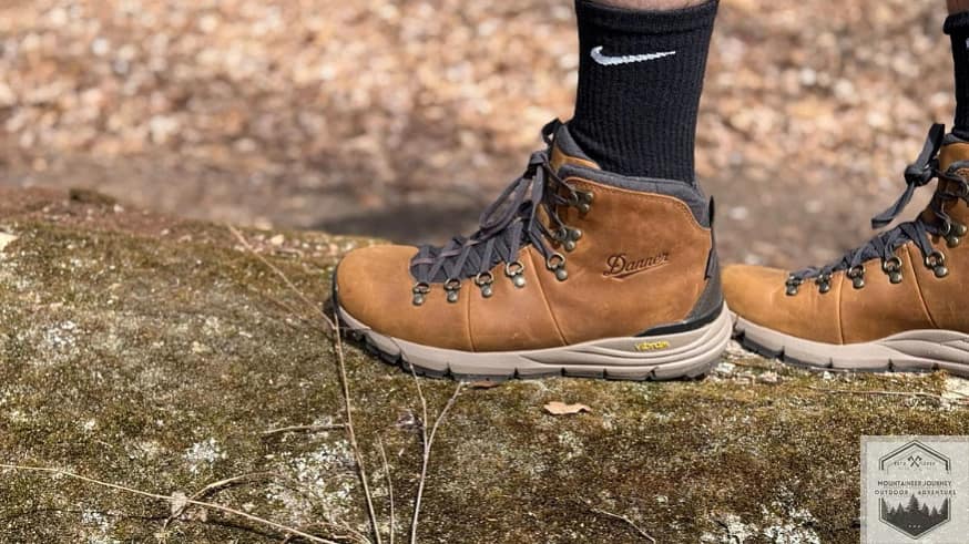 Showing the Vibram megarip outsole holding grip onto a large tree branch on the ground