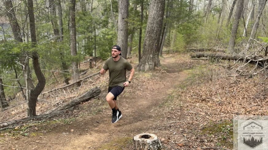 Uphill trail running in Hoka Clifton 10 to test ankle stability on uneven ground.