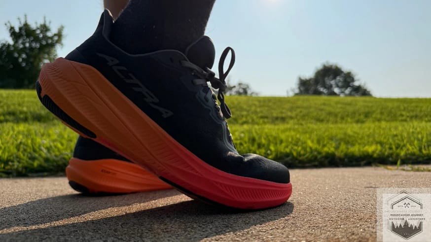 Standing in the Altra Experience Flow 2 on concrete demonstrating the underfoot comfort and rockered outsole geometry