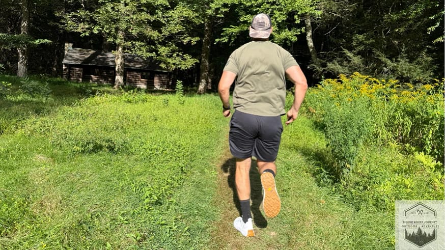 Running on a dirt covered path testing the Norda 001 trail shoe