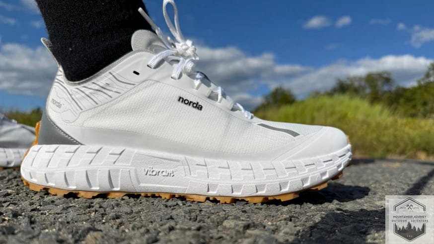 View of the Norda 001 on gravel with blue sky in back