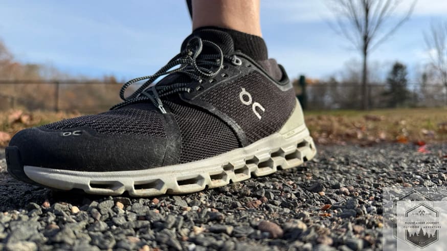 Full front view of the On Cloud 6 on a gravel path, highlighting the breathable engineered mesh upper and the signature speed lacing system for a secure, adjustable fit.