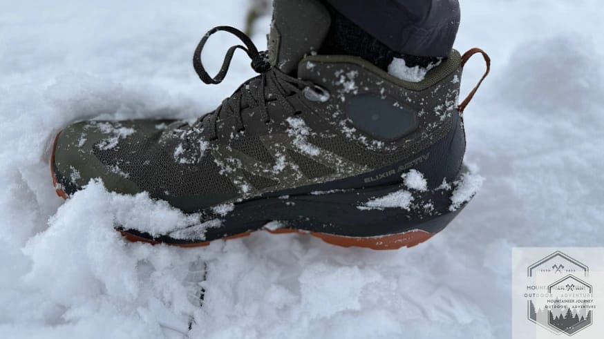 Salomon Elixir Activ completely submerged in snow during waterproof testing with zero leakage.