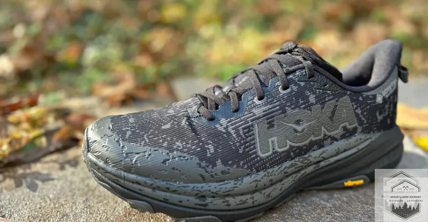 Hoka Speedgoat 6 showing the new and improved upper on a rock wall