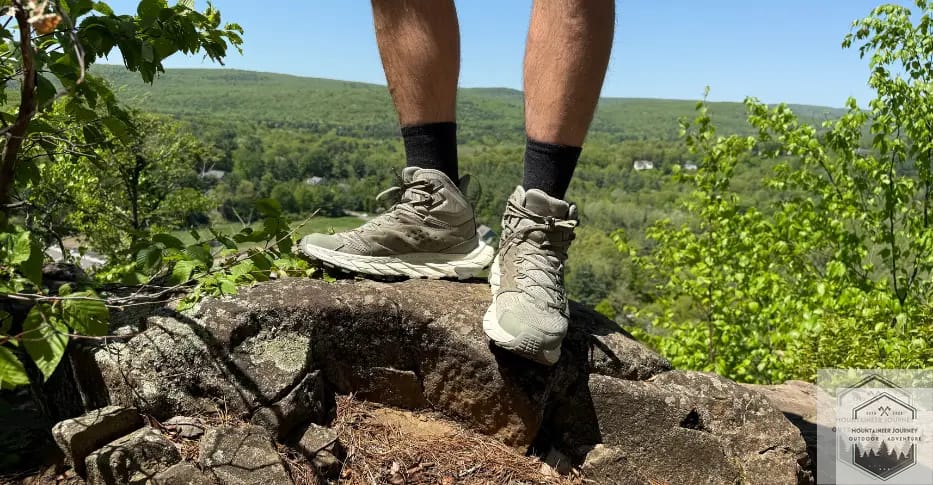 Wearing Darn Tough Light Hiker Micro Cushion with boots on top of mountain